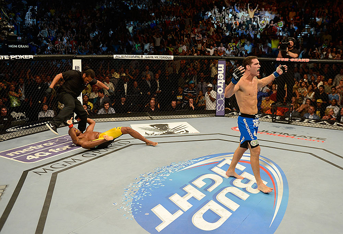 LAS VEGAS, NV - JULY 06:  Chris Weidman (right) reacts to his knockout victory over Anderson Silva in their UFC middleweight championship fight during the UFC 162 event inside the MGM Grand Garden Arena on July 6, 2013 in Las Vegas, Nevada.  (Photo by Donald Miralle/Zuffa LLC/Zuffa LLC via Getty Images) *** Local Caption *** Anderson Silva; Chris Weidman