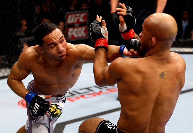 CHICAGO, IL - JANUARY 26:  John Dodson (L) punches Demetrious Johnson (R) during thier Flyweight Championship Bout part of UFC on FOX at United Center on January 26, 2013 in Chicago, Illinois.  (Photo by Al Bello/Zuffa LLC/Zuffa LLC Via Getty Images)