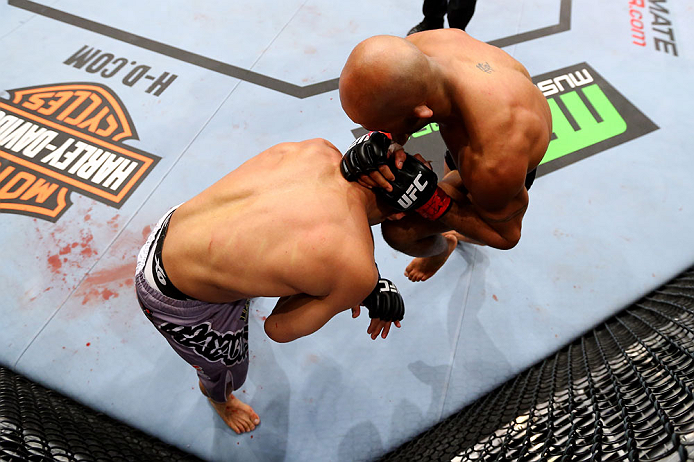 CHICAGO, IL - JANUARY 26:  Demetrious Johnson (L) knees John Dodson (R) during thier Flyweight Championship Bout part of UFC on FOX at United Center on January 26, 2013 in Chicago, Illinois.  (Photo by Al Bello/Zuffa LLC/Zuffa LLC Via Getty Images)