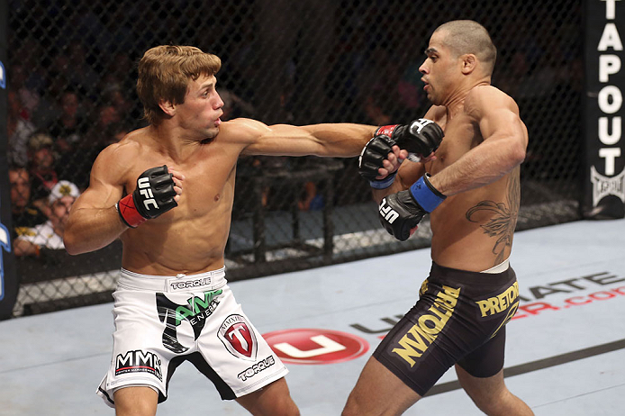 CALGARY, CANADA - JULY 21: (L-R) Urijah Faber throws a punch at Renan Barao during their UFC interim bantamweight championship bout at UFC 149 inside the Scotiabank Saddledome on July 21, 2012 in Calgary, Alberta, Canada.  (Photo by Nick Laham/Zuffa LLC/Zuffa LLC via Getty Images)