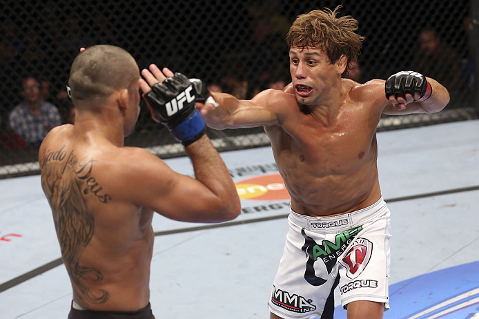 CALGARY, CANADA - JULY 21: (R-L) Urijah Faber throws a punch at Renan Barao during their UFC interim bantamweight championship bout at UFC 149 inside the Scotiabank Saddledome on July 21, 2012 in Calgary, Alberta, Canada.  (Photo by Nick Laham/Zuffa LLC/Zuffa LLC via Getty Images)