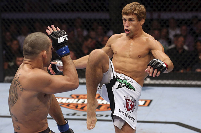 CALGARY, CANADA - JULY 21: (R-L) Urijah Faber attempts a kick to the body of Renan Barao during their UFC interim bantamweight championship bout at UFC 149 inside the Scotiabank Saddledome on July 21, 2012 in Calgary, Alberta, Canada.  (Photo by Nick Laham/Zuffa LLC/Zuffa LLC via Getty Images)