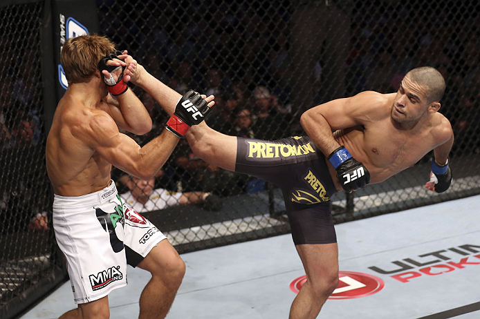 CALGARY, CANADA - JULY 21: (L-R) Urijah Faber blocks a kick from Renan Barao during their UFC interim bantamweight championship bout at UFC 149 inside the Scotiabank Saddledome on July 21, 2012 in Calgary, Alberta, Canada.  (Photo by Nick Laham/Zuffa LLC/Zuffa LLC via Getty Images)