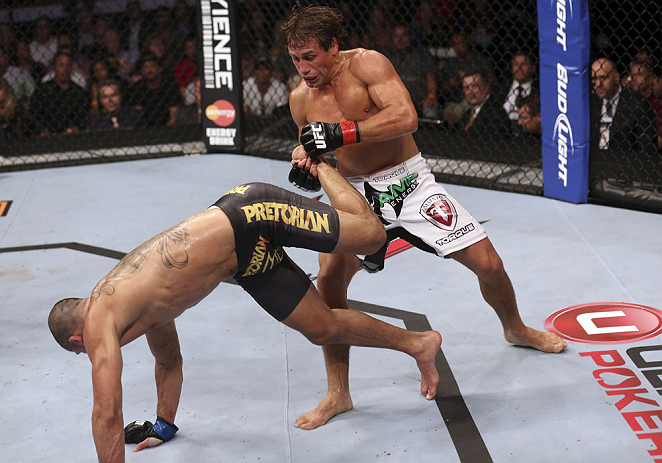 CALGARY, CANADA - JULY 21: (R-L) Urijah Faber counters a kick from Renan Barao during their UFC interim bantamweight championship bout at UFC 149 inside the Scotiabank Saddledome on July 21, 2012 in Calgary, Alberta, Canada.  (Photo by Nick Laham/Zuffa LLC/Zuffa LLC via Getty Images)