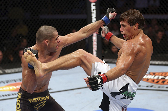 CALGARY, CANADA - JULY 21: (L-R) Renan Barao blocks a kick from Urijah Faber during their UFC interim bantamweight championship bout at UFC 149 inside the Scotiabank Saddledome on July 21, 2012 in Calgary, Alberta, Canada.  (Photo by Nick Laham/Zuffa LLC/Zuffa LLC via Getty Images)