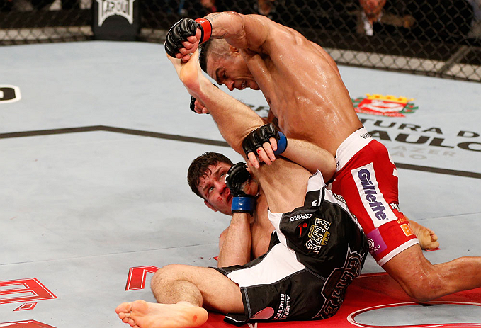 SAO PAULO, BRAZIL - JANUARY 19: Vitor Belfort (top) punches down at Michael Bisping in their middleweight fight at the UFC on FX event on January 19, 2013 at Ibirapuera Gymnasium in Sao Paulo, Brazil. (Photo by Josh Hedges/Zuffa LLC/Zuffa LLC via Getty Images)