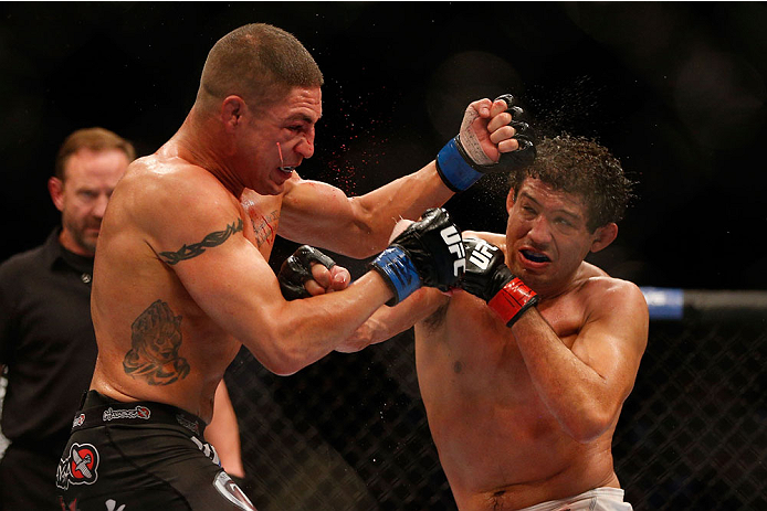 HOUSTON, TEXAS - OCTOBER 19:  (R-L) Gilbert Melendez punches Diego Sanchez in their UFC lightweight bout at the Toyota Center on October 19, 2013 in Houston, Texas. (Photo by Josh Hedges/Zuffa LLC/Zuffa LLC via Getty Images)