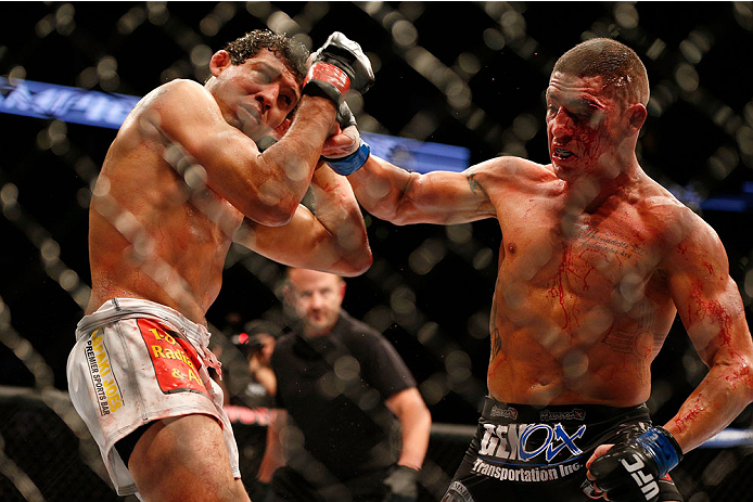 HOUSTON, TEXAS - OCTOBER 19:  (R-L) Diego Sanchez punches Gilbert Melendez in their UFC lightweight bout at the Toyota Center on October 19, 2013 in Houston, Texas. (Photo by Josh Hedges/Zuffa LLC/Zuffa LLC via Getty Images)