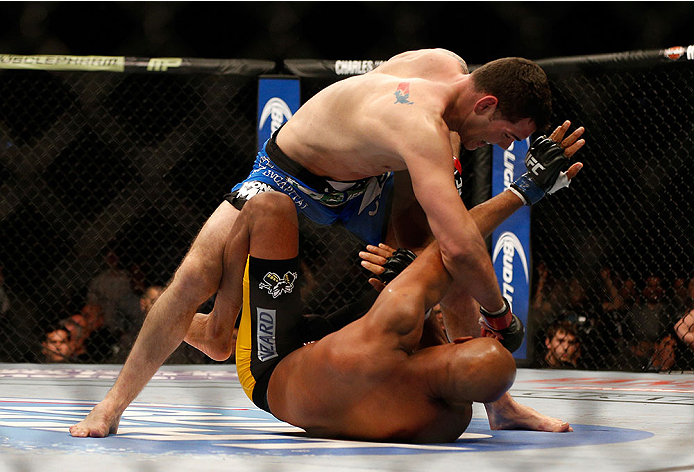 LAS VEGAS, NV - DECEMBER 28:  Chris Weidman (top) punches Anderson Silva in their UFC middleweight championship bout during the UFC 168 event at the MGM Grand Garden Arena on December 28, 2013 in Las Vegas, Nevada. (Photo by Josh Hedges/Zuffa LLC/Zuffa LLC via Getty Images) *** Local Caption *** Chris Weidman; Anderson Silva