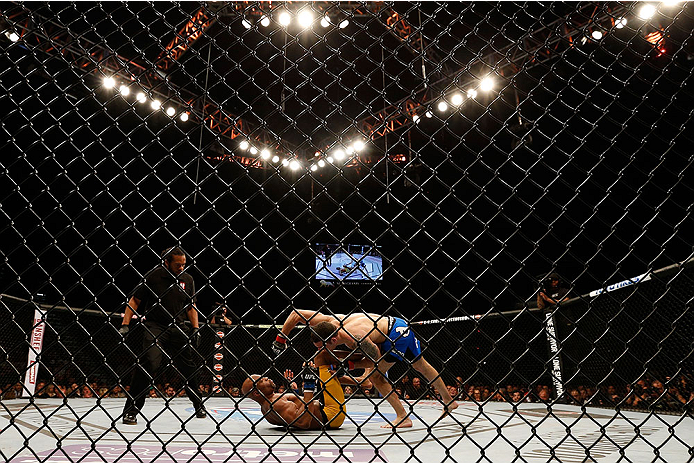 LAS VEGAS, NV - DECEMBER 28:  Chris Weidman (top) punches Anderson Silva in their UFC middleweight championship bout during the UFC 168 event at the MGM Grand Garden Arena on December 28, 2013 in Las Vegas, Nevada. (Photo by Josh Hedges/Zuffa LLC/Zuffa LLC via Getty Images) *** Local Caption *** Chris Weidman; Anderson Silva