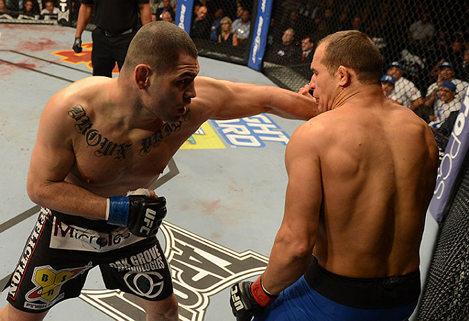 LAS VEGAS, NV - DECEMBER 29:  (L-R) Cain Velasquez punches Junior dos Santos during their heavyweight championship fight at UFC 155 on December 29, 2012 at MGM Grand Garden Arena in Las Vegas, Nevada. (Photo by Donald Miralle/Zuffa LLC/Zuffa LLC via Getty Images) *** Local Caption *** Junior dos Santos; Cain Velasquez