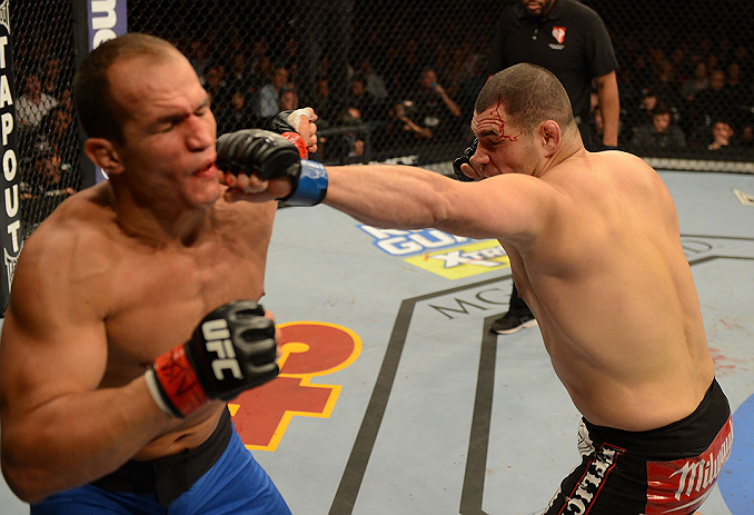 LAS VEGAS, NV - DECEMBER 29:  (R-L) Cain Velasquez punches Junior dos Santos during their heavyweight championship fight at UFC 155 on December 29, 2012 at MGM Grand Garden Arena in Las Vegas, Nevada. (Photo by Donald Miralle/Zuffa LLC/Zuffa LLC via Getty Images) *** Local Caption *** Junior dos Santos; Cain Velasquez