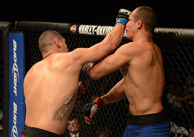 LAS VEGAS, NV - DECEMBER 29:  (L-R) Cain Velasquez punches Junior dos Santos during their heavyweight championship fight at UFC 155 on December 29, 2012 at MGM Grand Garden Arena in Las Vegas, Nevada. (Photo by Donald Miralle/Zuffa LLC/Zuffa LLC via Getty Images) *** Local Caption *** Junior dos Santos; Cain Velasquez