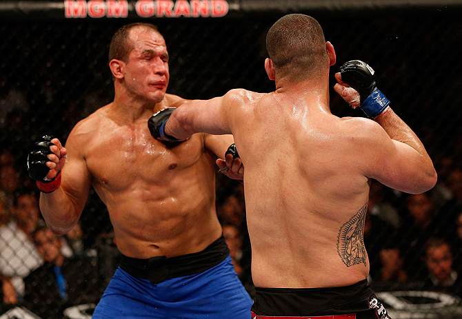 LAS VEGAS, NV - DECEMBER 29:  (R-L) Cain Velasquez punches Junior dos Santos during their heavyweight championship fight at UFC 155 on December 29, 2012 at MGM Grand Garden Arena in Las Vegas, Nevada. (Photo by Josh Hedges/Zuffa LLC/Zuffa LLC via Getty Images) *** Local Caption *** Junior dos Santos; Cain Velasquez