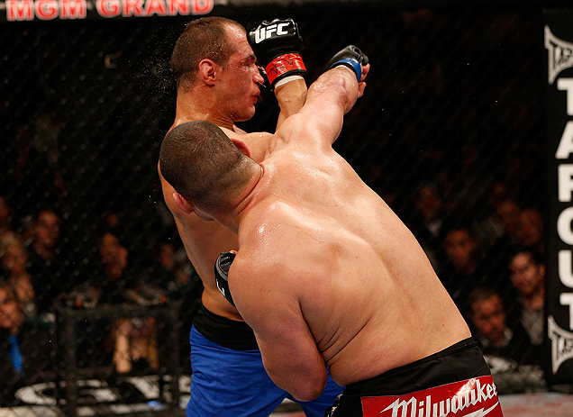 LAS VEGAS, NV - DECEMBER 29:  (R-L) Cain Velasquez punches Junior dos Santos during their heavyweight championship fight at UFC 155 on December 29, 2012 at MGM Grand Garden Arena in Las Vegas, Nevada. (Photo by Josh Hedges/Zuffa LLC/Zuffa LLC via Getty Images) *** Local Caption *** Junior dos Santos; Cain Velasquez