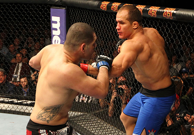 LAS VEGAS, NV - DECEMBER 29:  (L-R) Junior dos Santos punches Cain Velasquez during their heavyweight championship fight at UFC 155 on December 29, 2012 at MGM Grand Garden Arena in Las Vegas, Nevada. (Photo by Josh Hedges/Zuffa LLC/Zuffa LLC via Getty Images) *** Local Caption *** Junior dos Santos; Cain Velasquez
