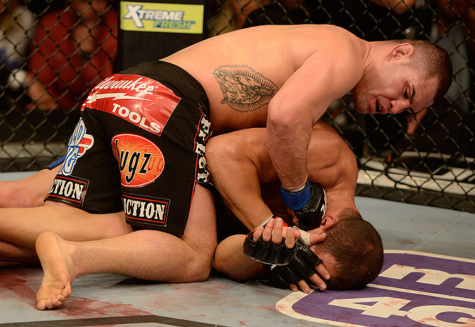 LAS VEGAS, NV - DECEMBER 29:  Cain Velasquez (top) punches Junior dos Santos during their heavyweight championship fight at UFC 155 on December 29, 2012 at MGM Grand Garden Arena in Las Vegas, Nevada. (Photo by Donald Miralle/Zuffa LLC/Zuffa LLC via Getty Images) *** Local Caption *** Junior dos Santos; Cain Velasquez
