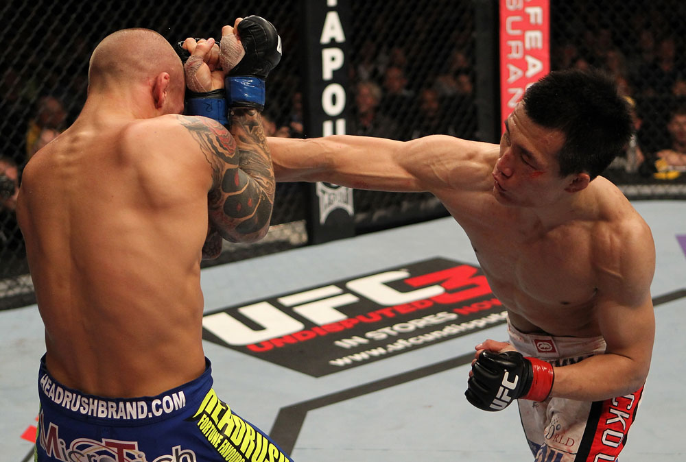 FAIRFAX, VA - MAY 15:  (R-L) "The Korean Zombie" Chan Sung Jung punches Dustin Poirier in a featherweight bout during the UFC on Fuel TV event at Patriot Center on May 15, 2012 in Fairfax, Virginia.  (Photo by Josh Hedges/Zuffa LLC/Zuffa LLC via Getty Images)