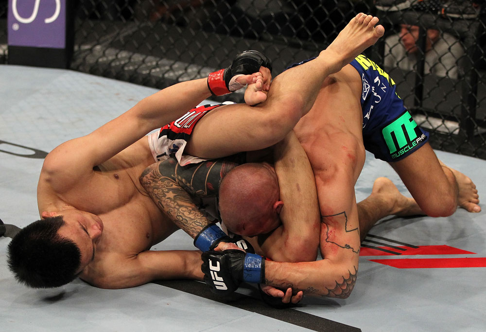 FAIRFAX, VA - MAY 15:  (L-R) "The Korean Zombie" Chan Sung Jung attempts to secure a triangle choke submission against Dustin Poirier in a featherweight bout during the UFC on Fuel TV event at Patriot Center on May 15, 2012 in Fairfax, Virginia.  (Photo by Josh Hedges/Zuffa LLC/Zuffa LLC via Getty Images)