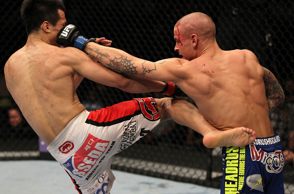FAIRFAX, VA - MAY 15:  (L-R) "The Korean Zombie" Chan Sung Jung and Dustin Poirier trade strikes in a featherweight bout during the UFC on Fuel TV event at Patriot Center on May 15, 2012 in Fairfax, Virginia.  (Photo by Josh Hedges/Zuffa LLC/Zuffa LLC via Getty Images)
