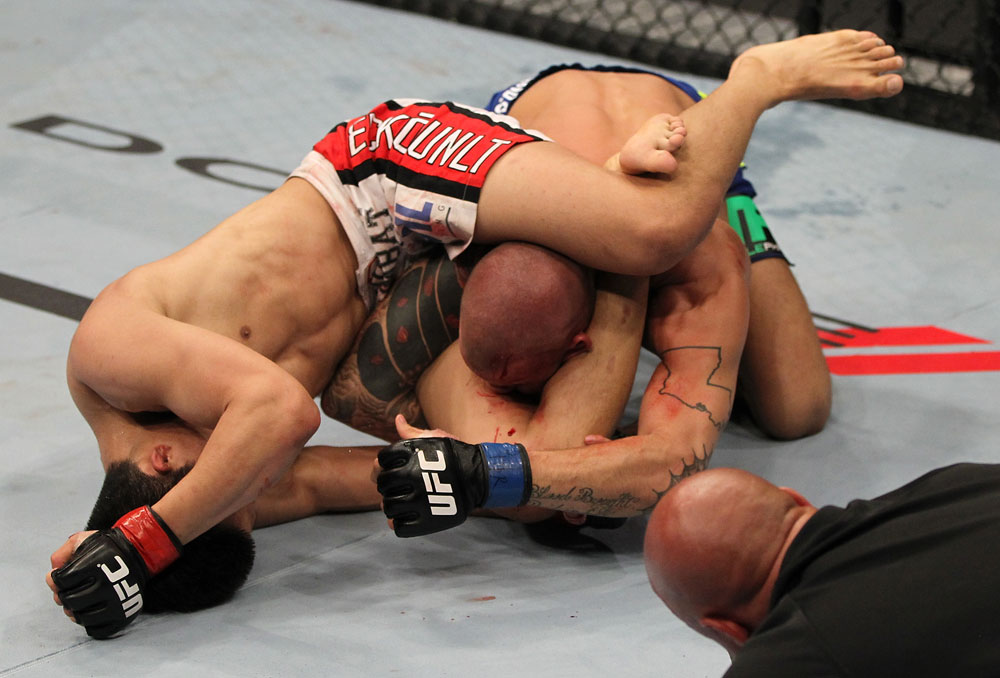 FAIRFAX, VA - MAY 15:  (L-R) "The Korean Zombie" Chan Sung Jung attempts to secure a triangle choke submission against Dustin Poirier in a featherweight bout during the UFC on Fuel TV event at Patriot Center on May 15, 2012 in Fairfax, Virginia.  (Photo by Josh Hedges/Zuffa LLC/Zuffa LLC via Getty Images)
