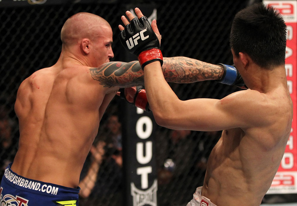 FAIRFAX, VA - MAY 15:  (L-R) Dustin Poirier punches "The Korean Zombie" Chan Sung Jung in a featherweight bout during the UFC on Fuel TV event at Patriot Center on May 15, 2012 in Fairfax, Virginia.  (Photo by Josh Hedges/Zuffa LLC/Zuffa LLC via Getty Images)