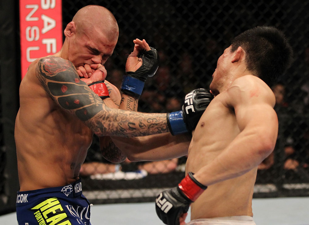 FAIRFAX, VA - MAY 15:  (R-L) "The Korean Zombie" Chan Sung Jung punches Dustin Poirier in a featherweight bout during the UFC on Fuel TV event at Patriot Center on May 15, 2012 in Fairfax, Virginia.  (Photo by Josh Hedges/Zuffa LLC/Zuffa LLC via Getty Images)