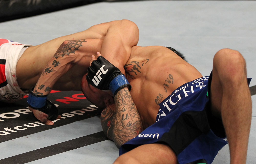 FAIRFAX, VA - MAY 15:  (L-R) "The Korean Zombie" Chan Sung Jung defeats Dustin Poirier with a d'arce choke submission in a featherweight bout during the UFC on Fuel TV event at Patriot Center on May 15, 2012 in Fairfax, Virginia.  (Photo by Josh Hedges/Zuffa LLC/Zuffa LLC via Getty Images)