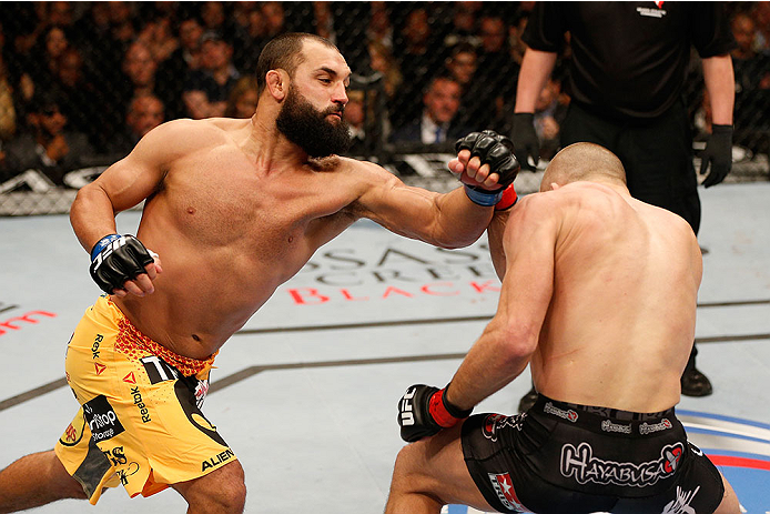 LAS VEGAS, NV - NOVEMBER 16:  (L-R) Johny Hendricks punches Georges St-Pierre in their UFC welterweight championship bout during the UFC 167 event inside the MGM Grand Garden Arena on November 16, 2013 in Las Vegas, Nevada. (Photo by Josh Hedges/Zuffa LLC/Zuffa LLC via Getty Images) *** Local Caption *** Georges St-Pierre; Johny Hendricks