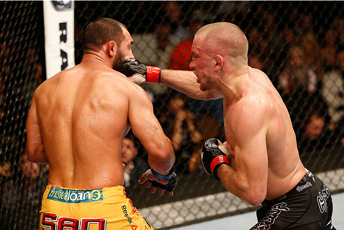 LAS VEGAS, NV - NOVEMBER 16:  (R-L) Georges St-Pierre punches Johny Hendricks in their UFC welterweight championship bout during the UFC 167 event inside the MGM Grand Garden Arena on November 16, 2013 in Las Vegas, Nevada. (Photo by Josh Hedges/Zuffa LLC/Zuffa LLC via Getty Images) *** Local Caption *** Georges St-Pierre; Johny Hendricks