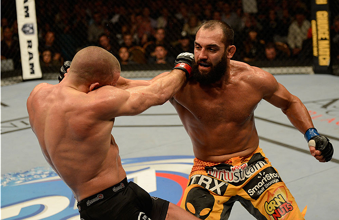 LAS VEGAS, NV - NOVEMBER 16:  (R-L) Johny Hendricks punches Georges St-Pierre in their UFC welterweight championship bout during the UFC 167 event inside the MGM Grand Garden Arena on November 16, 2013 in Las Vegas, Nevada. (Photo by Donald Miralle/Zuffa LLC/Zuffa LLC via Getty Images) *** Local Caption *** Georges St-Pierre; Johny Hendricks