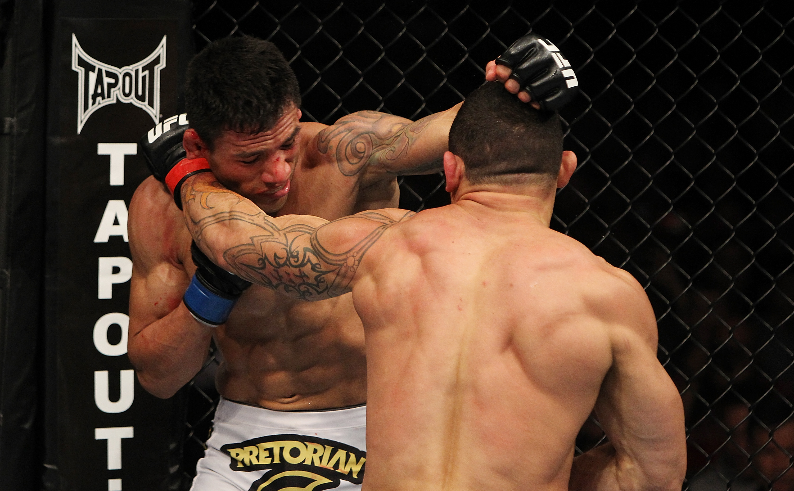 SAN JOSE, CA - NOVEMBER 19: (R-L) Gleison Tibau punches Rafael dos Anjos during an UFC Lightweight bout at the HP Pavillion in San Jose, California on November 19, 2011 in San Jose, California. (Photo by Josh Hedges/Zuffa LLC/Zuffa LLC via Getty Images)