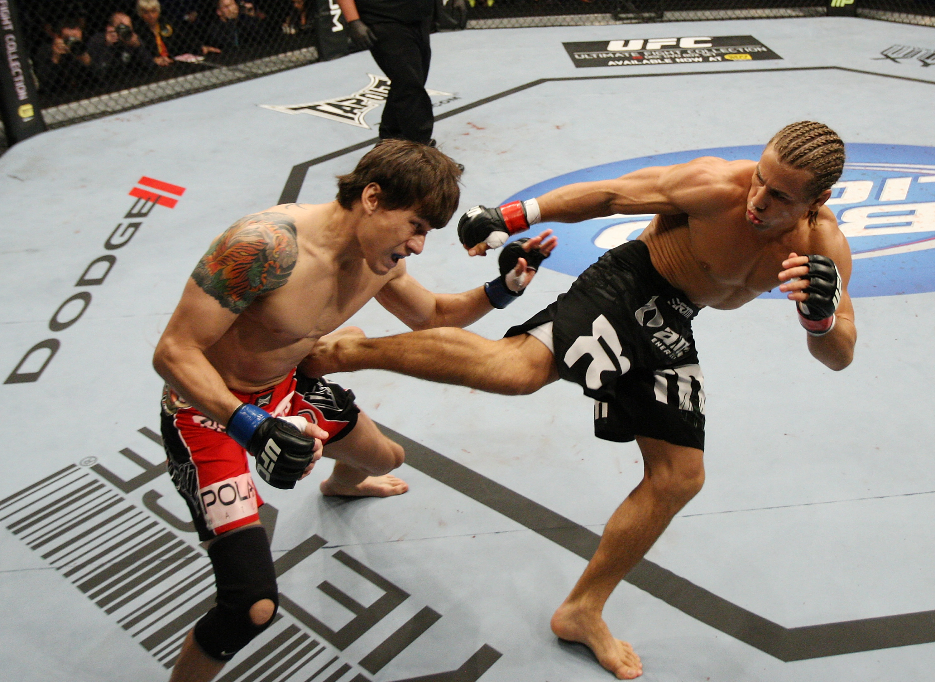 SAN JOSE, CA - NOVEMBER 19: (R-L) Urijah Faber kicks Brian Bowles in the side during an UFC Bantamweight bout at the HP Pavillion on November 19, 2011 in San Jose, California. (Photo by Josh Hedges/Zuffa LLC/Zuffa LLC via Getty Images)