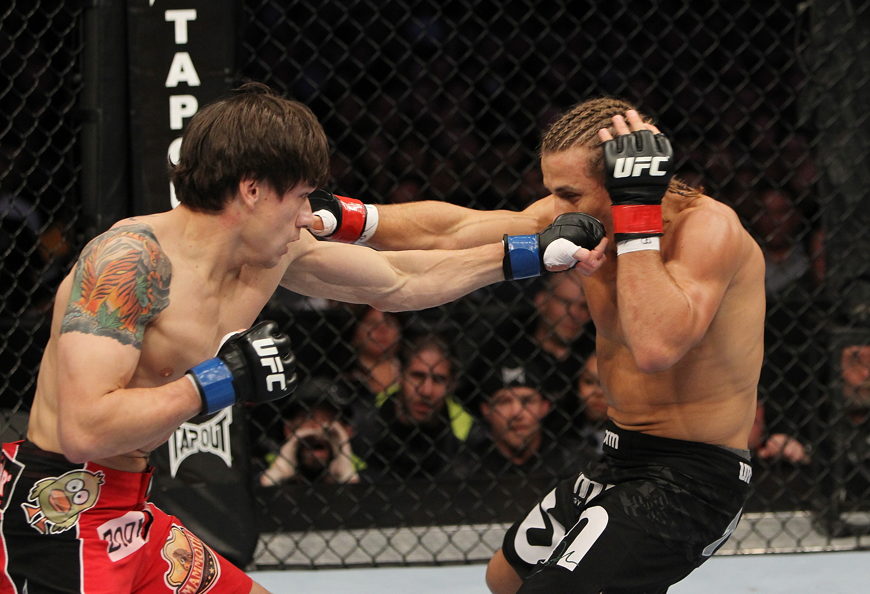 SAN JOSE, CA - NOVEMBER 19: (L-R) Brian Bowles punches Urijah Faber during an UFC Bantamweight bout at the HP Pavillion on November 19, 2011 in San Jose, California. (Photo by Josh Hedges/Zuffa LLC/Zuffa LLC via Getty Images)