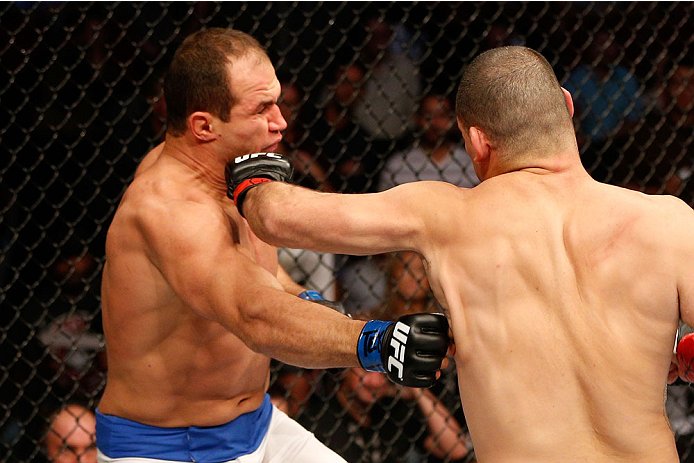 HOUSTON, TEXAS - OCTOBER 19:  (R-L) Cain Velasquez punches Junior Dos Santos in their UFC heavyweight championship bout at the Toyota Center on October 19, 2013 in Houston, Texas. (Photo by Josh Hedges/Zuffa LLC/Zuffa LLC via Getty Images)