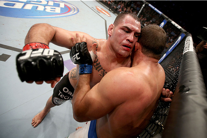 HOUSTON, TEXAS - OCTOBER 19:  (L-R) Cain Velasquez punches Junior Dos Santos in their UFC heavyweight championship bout at the Toyota Center on October 19, 2013 in Houston, Texas. (Photo by Nick Laham/Zuffa LLC/Zuffa LLC via Getty Images)