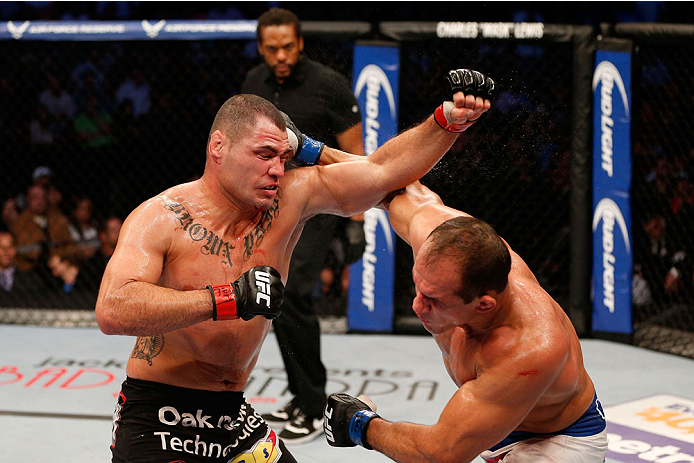 HOUSTON, TEXAS - OCTOBER 19:  (R-L) Junior Dos Santos punches Cain Velasquez in their UFC heavyweight championship bout at the Toyota Center on October 19, 2013 in Houston, Texas. (Photo by Josh Hedges/Zuffa LLC/Zuffa LLC via Getty Images)