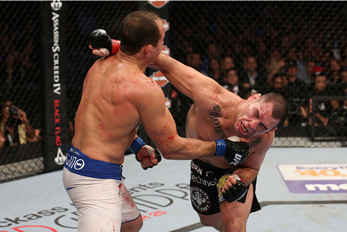 HOUSTON, TEXAS - OCTOBER 19:  (R-L) Cain Velasquez punches Junior Dos Santos in their UFC heavyweight championship bout at the Toyota Center on October 19, 2013 in Houston, Texas. (Photo by Nick Laham/Zuffa LLC/Zuffa LLC via Getty Images)