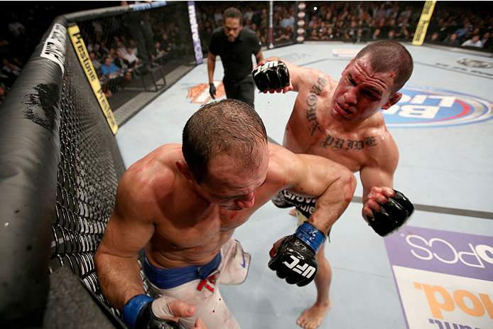 HOUSTON, TEXAS - OCTOBER 19:  (R-L) Cain Velasquez punches Junior Dos Santos in their UFC heavyweight championship bout at the Toyota Center on October 19, 2013 in Houston, Texas. (Photo by Nick Laham/Zuffa LLC/Zuffa LLC via Getty Images)