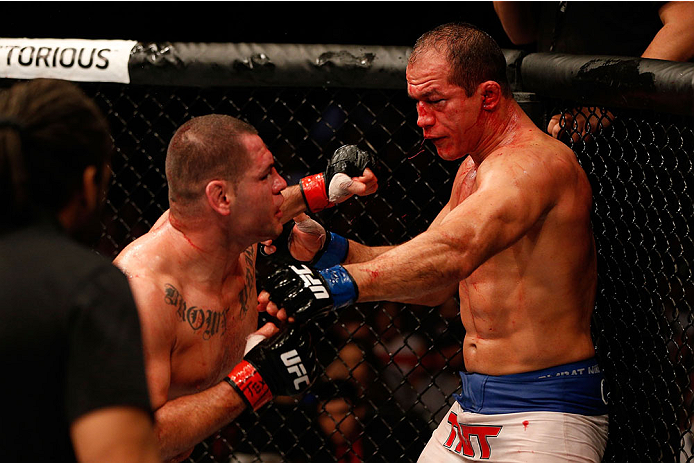 HOUSTON, TEXAS - OCTOBER 19:  (L-R) Cain Velasquez punches Junior Dos Santos in their UFC heavyweight championship bout at the Toyota Center on October 19, 2013 in Houston, Texas. (Photo by Josh Hedges/Zuffa LLC/Zuffa LLC via Getty Images)