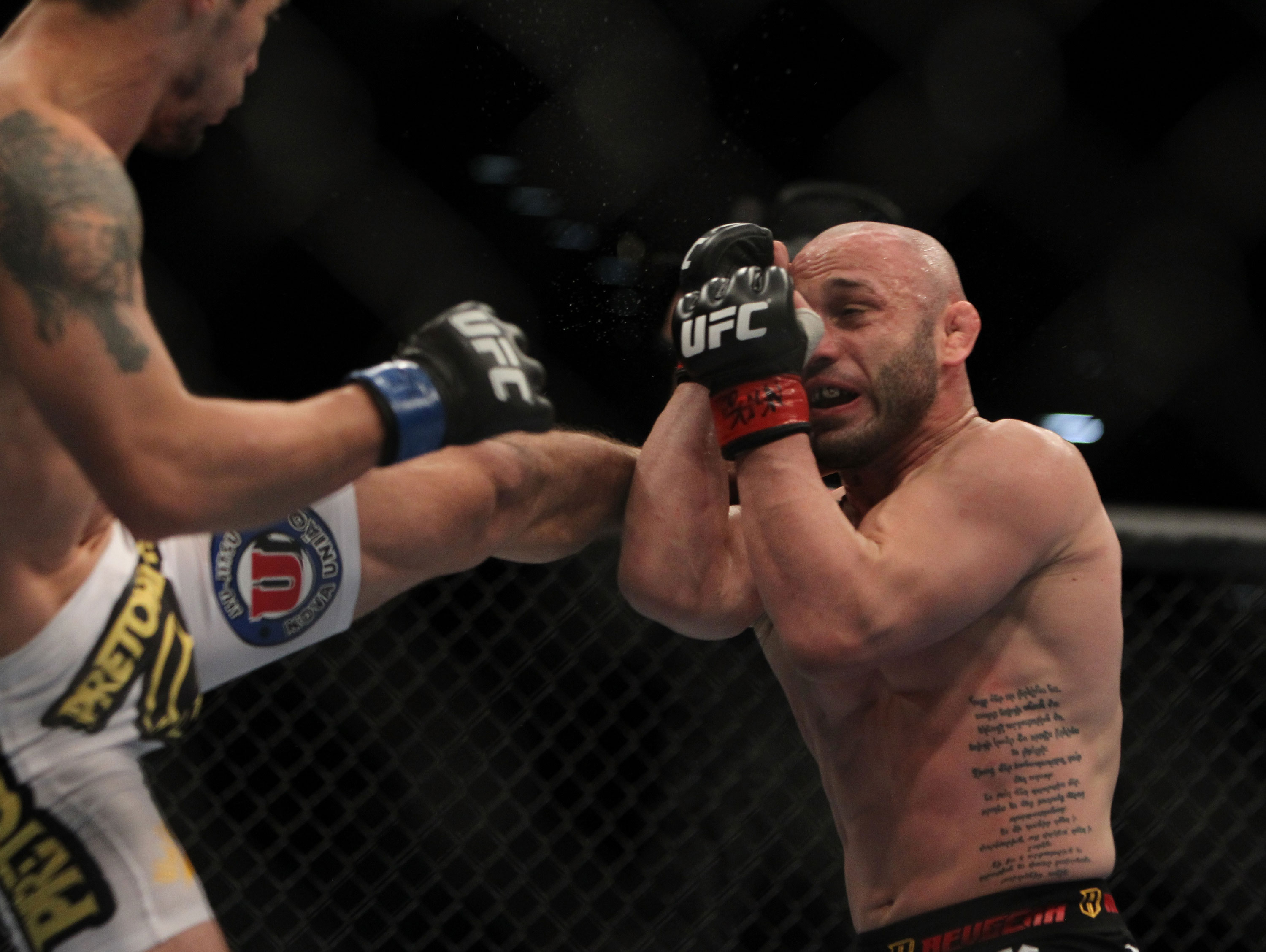 LAS VEGAS, NV - DECEMBER 30: Manny Gamburyan (right) blocks a kick thrown by Diego Nunes (left) during the UFC 141 event at the MGM Grand Garden Arena on December 30, 2011 in Las Vegas, Nevada. (Photo by Josh Hedges/Zuffa LLC/Zuffa LLC via Getty Images) *** Local Caption *** Manny Gamburyan; Diego Nues
