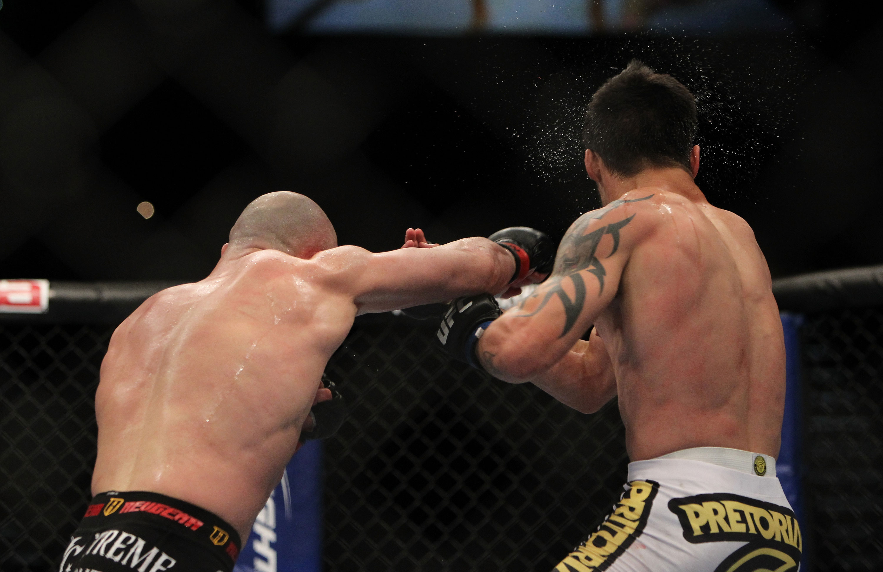 LAS VEGAS, NV - DECEMBER 30: Manny Gamburyan (left) punches Diego Nunes (right) during the UFC 141 event at the MGM Grand Garden Arena on December 30, 2011 in Las Vegas, Nevada. (Photo by Josh Hedges/Zuffa LLC/Zuffa LLC via Getty Images) *** Local Caption *** Manny Gamburyan; Diego Nunes