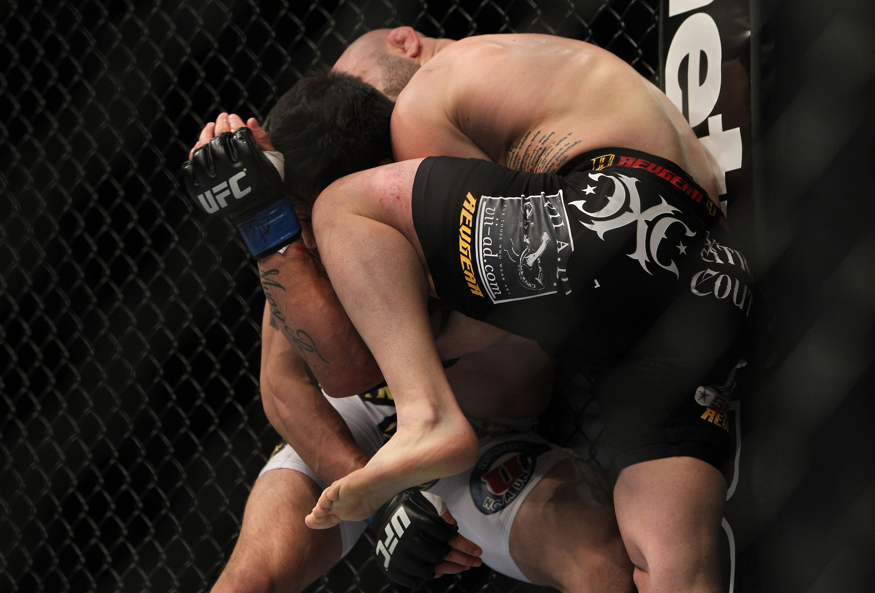 LAS VEGAS, NV - DECEMBER 30: Manny Gamburyan (black shorts) knees Diego Nunes during the UFC 141 event at the MGM Grand Garden Arena on December 30, 2011 in Las Vegas, Nevada. (Photo by Josh Hedges/Zuffa LLC/Zuffa LLC via Getty Images) *** Local Caption *** Manny Gamburyan; Diego Nunes