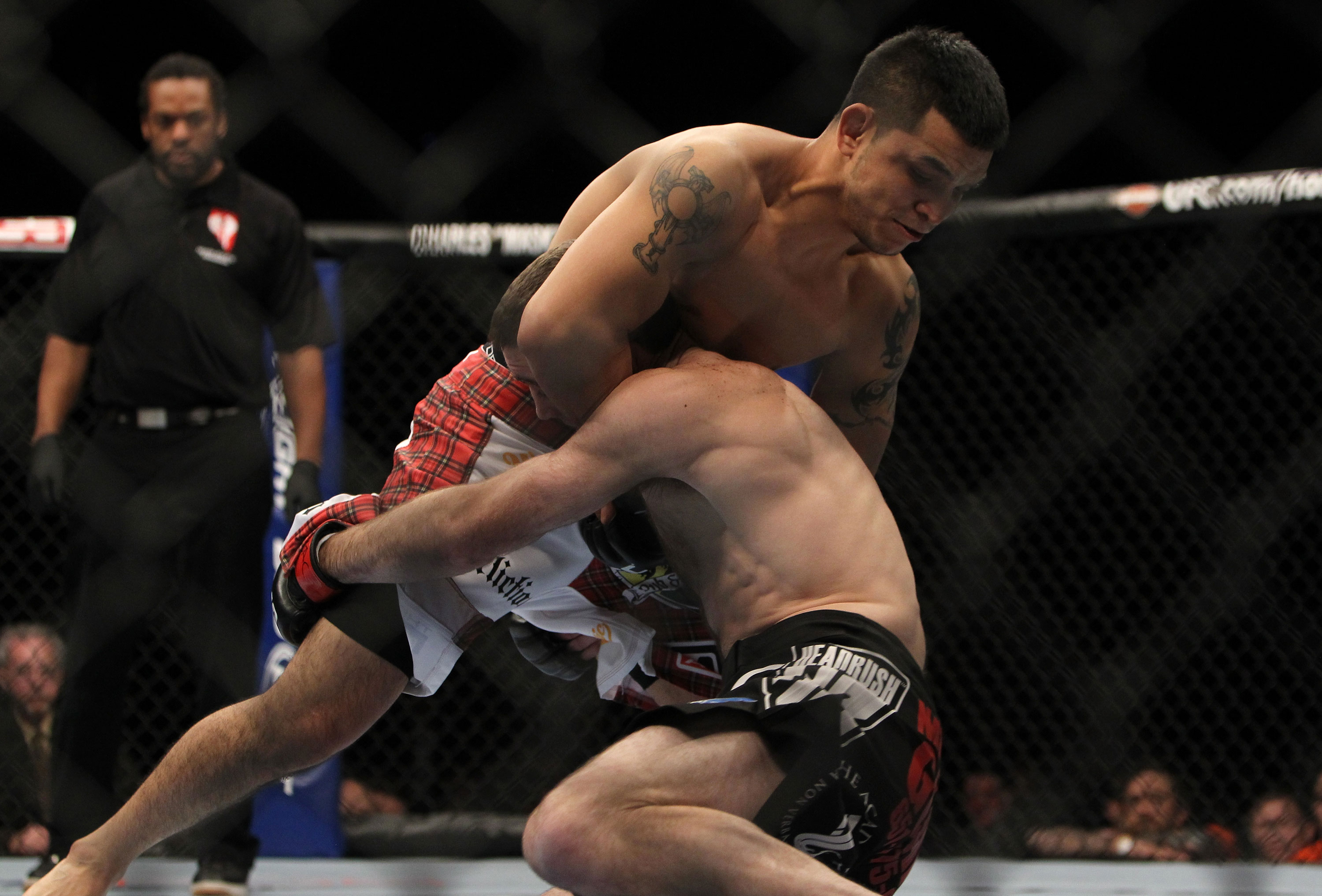 LAS VEGAS, NV - DECEMBER 30: Efrain Escudero (white shorts) defends against a takedown from Jacob Volkmann (black shorts) during the UFC 141 event at the MGM Grand Garden Arena on December 30, 2011 in Las Vegas, Nevada. (Photo by Josh Hedges/Zuffa LLC/Zuffa LLC via Getty Images) *** Local Caption *** Jacob Volkmann; Efrain Escudero