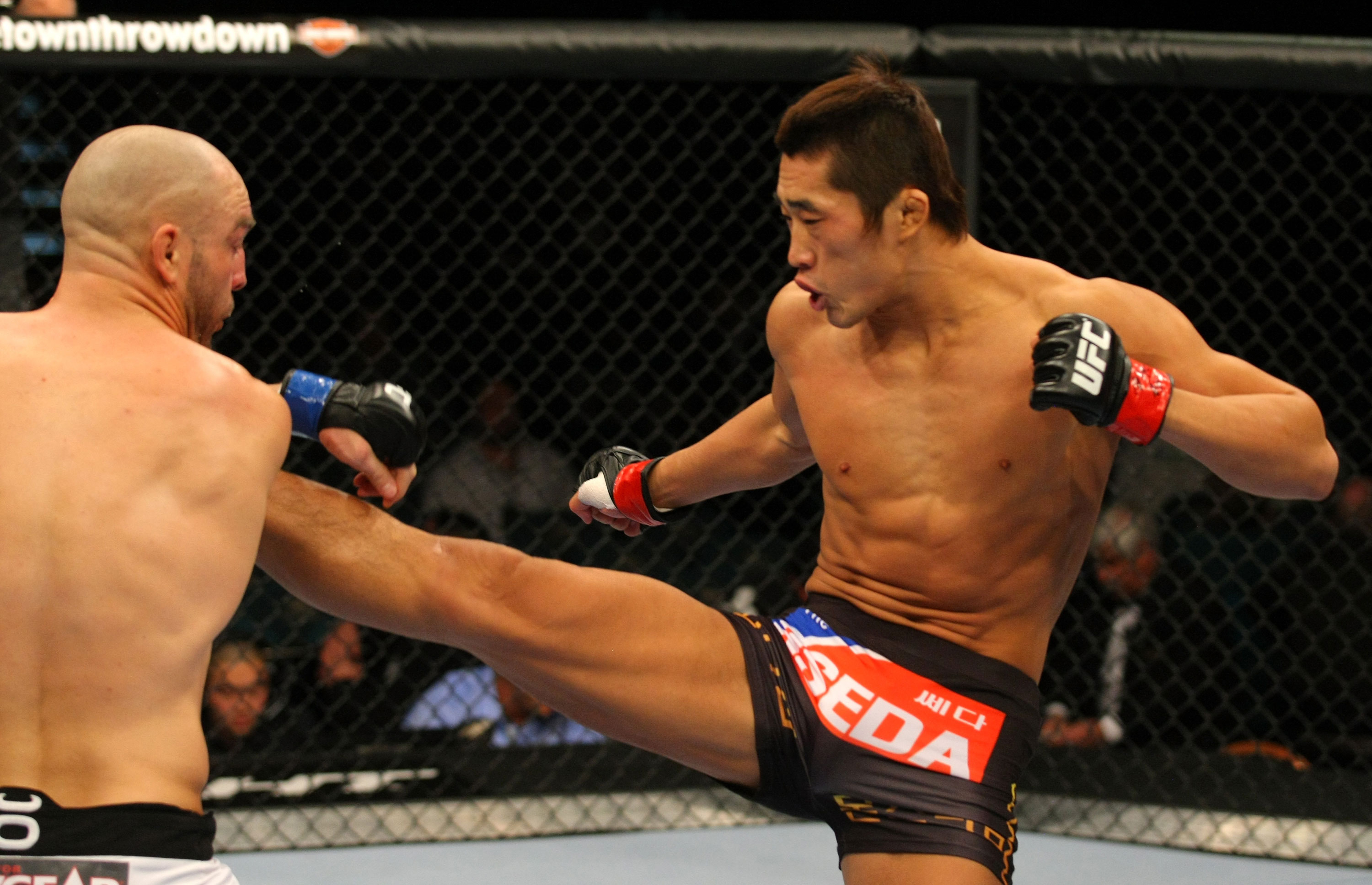 LAS VEGAS, NV - DECEMBER 30: Dong Hyun Kim (right) throws a kick at Sean Pierson (left) during the UFC 141 event at the MGM Grand Garden Arena on December 30, 2011 in Las Vegas, Nevada. (Photo by Donald Miralle/Zuffa LLC/Zuffa LLC via Getty Images) *** Local Caption *** Dong Hyun Kim; Sean Pierson
