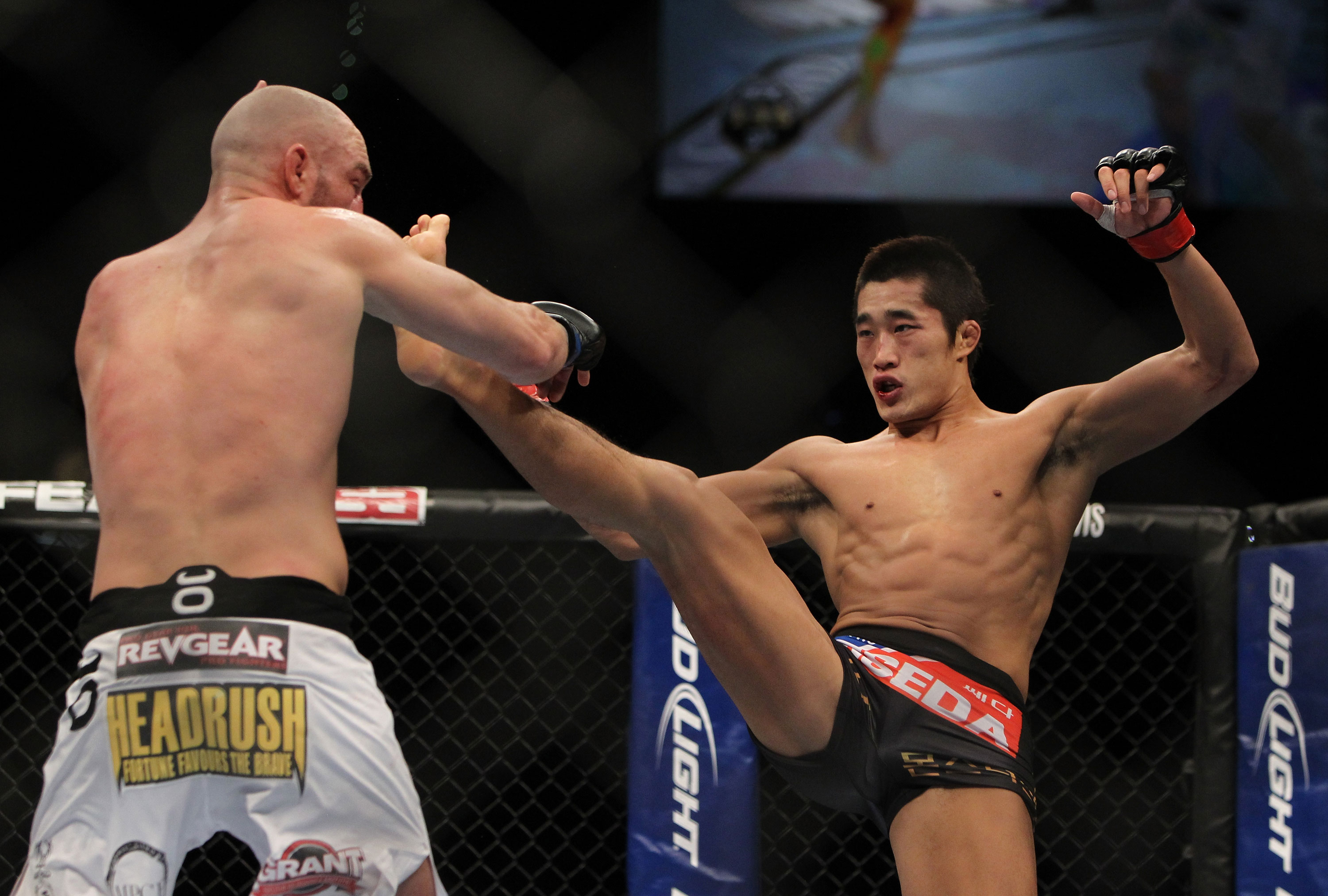 LAS VEGAS, NV - DECEMBER 30: Dong Hyun Kim (black shorts) throws a kick at Sean Pierson (white shorts) during the UFC 141 event at the MGM Grand Garden Arena on December 30, 2011 in Las Vegas, Nevada. (Photo by Josh Hedges/Zuffa LLC/Zuffa LLC via Getty Images) *** Local Caption *** Dong Hyun Kim; Sean Pierson