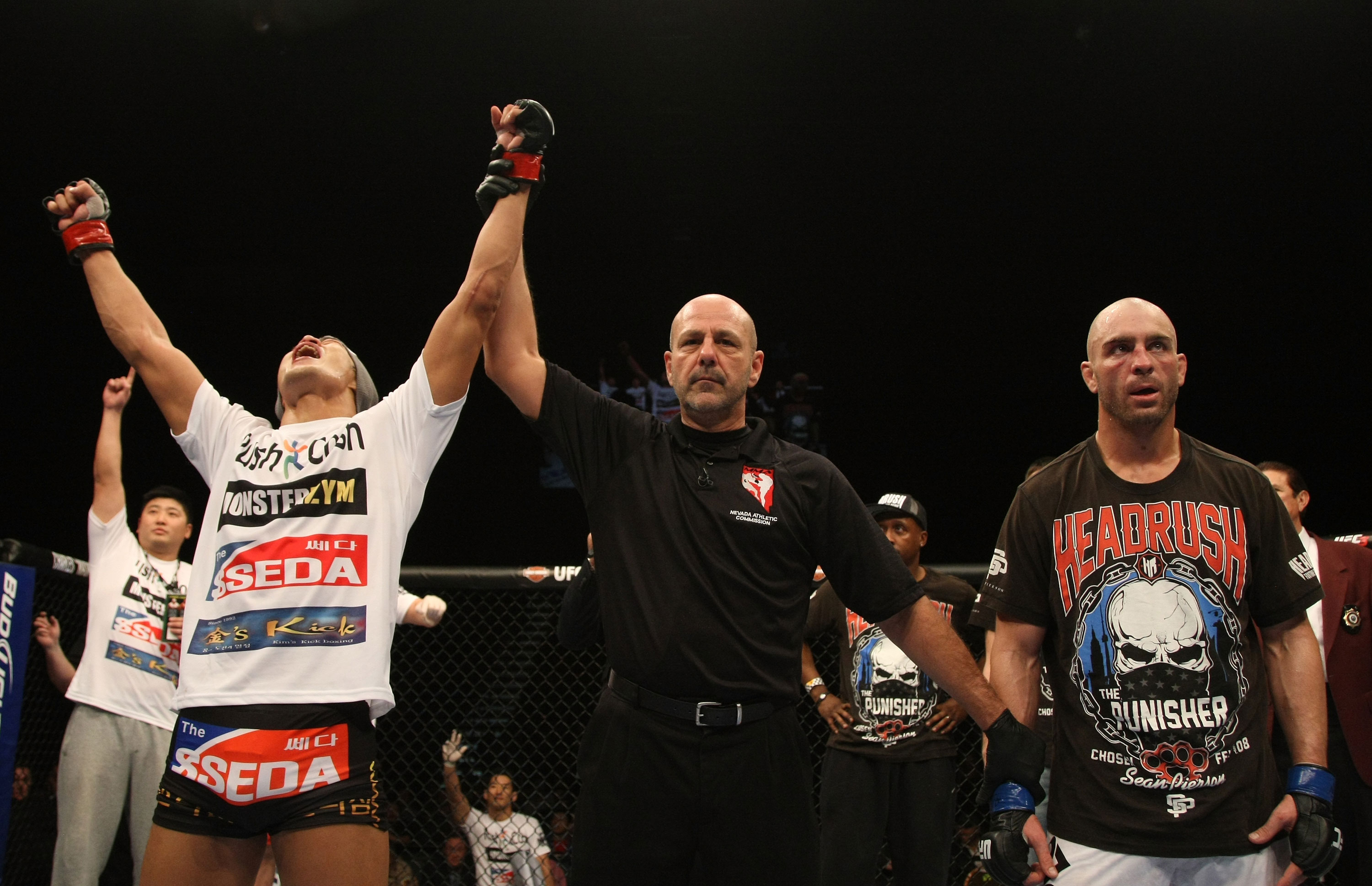 LAS VEGAS, NV - DECEMBER 30: Dong Hyun Kim (left) is declared the winner in his fight against Sean Pierson (right) during the UFC 141 event at the MGM Grand Garden Arena on December 30, 2011 in Las Vegas, Nevada. (Photo by Donald Miralle/Zuffa LLC/Zuffa LLC via Getty Images) *** Local Caption *** Dong Hyun Kim; Sean Pierson