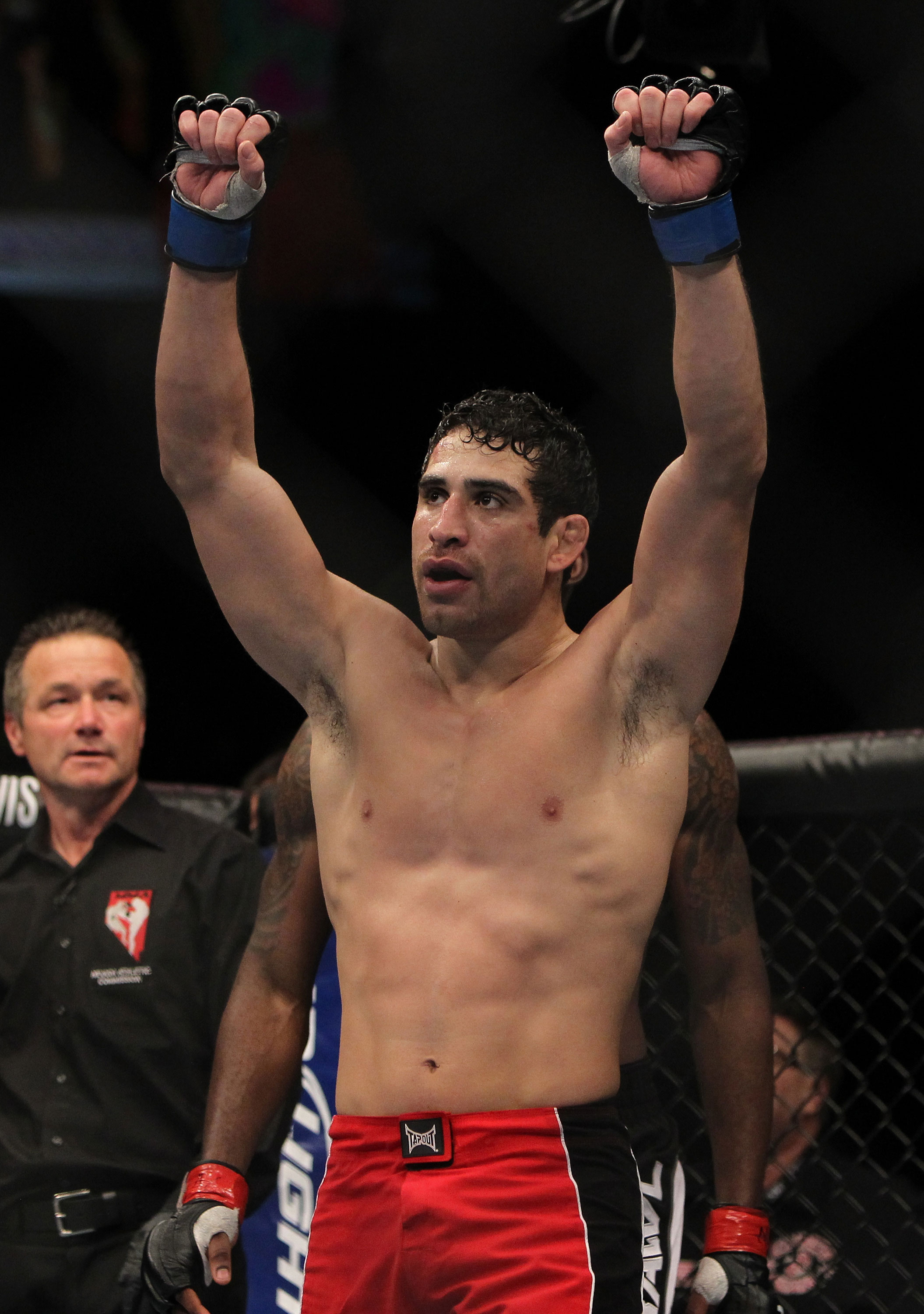 LAS VEGAS, NV - DECEMBER 30: Danny Castillo raises his hands after his fight with Anthony Njokuani during the UFC 141 event at the MGM Grand Garden Arena on December 30, 2011 in Las Vegas, Nevada. (Photo by Josh Hedges/Zuffa LLC/Zuffa LLC via Getty Images) *** Local Caption *** Danny Castillo