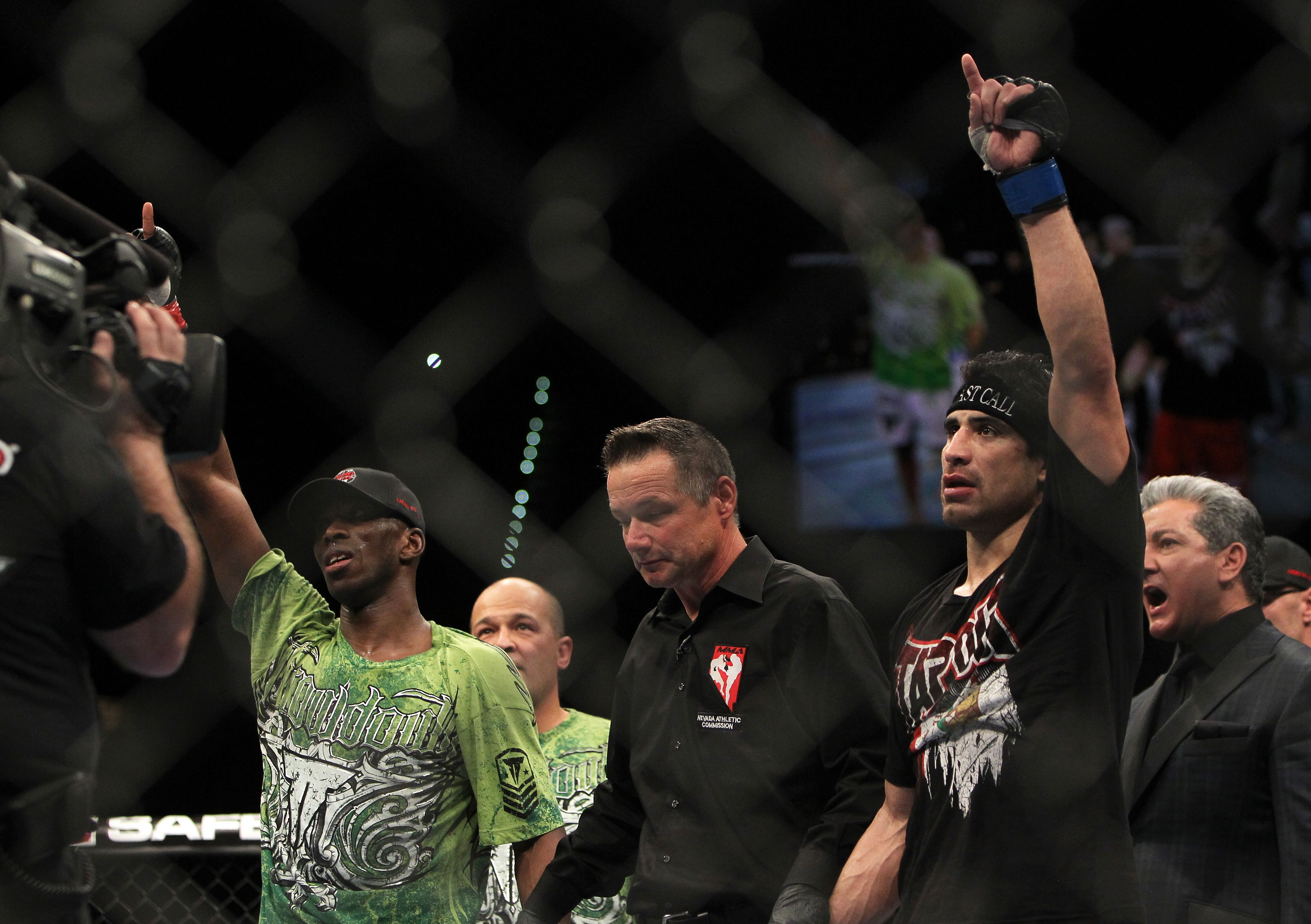 LAS VEGAS, NV - DECEMBER 30: Danny Castillo (right, black shirt) and Anthony Njokuani (green shirt) await the results of their fight during the UFC 141 event at the MGM Grand Garden Arena on December 30, 2011 in Las Vegas, Nevada. (Photo by Josh Hedges/Zuffa LLC/Zuffa LLC via Getty Images) *** Local Caption *** Danny Castillo; Anthony Njokuani