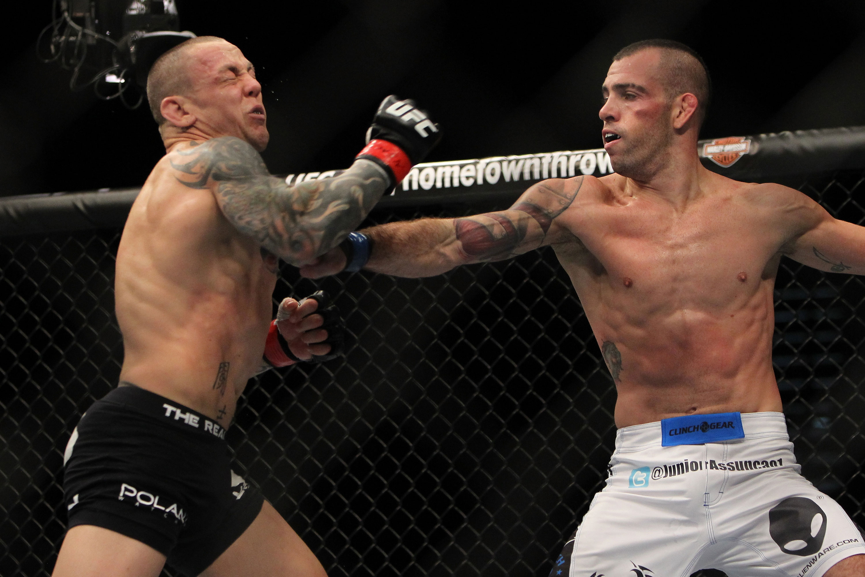 LAS VEGAS, NV - DECEMBER 30: Junior Assuncao (white shorts) punches Ross Pearson (black shorts) during the UFC 141 event at the MGM Grand Garden Arena on December 30, 2011 in Las Vegas, Nevada. (Photo by Josh Hedges/Zuffa LLC/Zuffa LLC via Getty Images) *** Local Caption *** Junior Assuncao; Ross Pearson